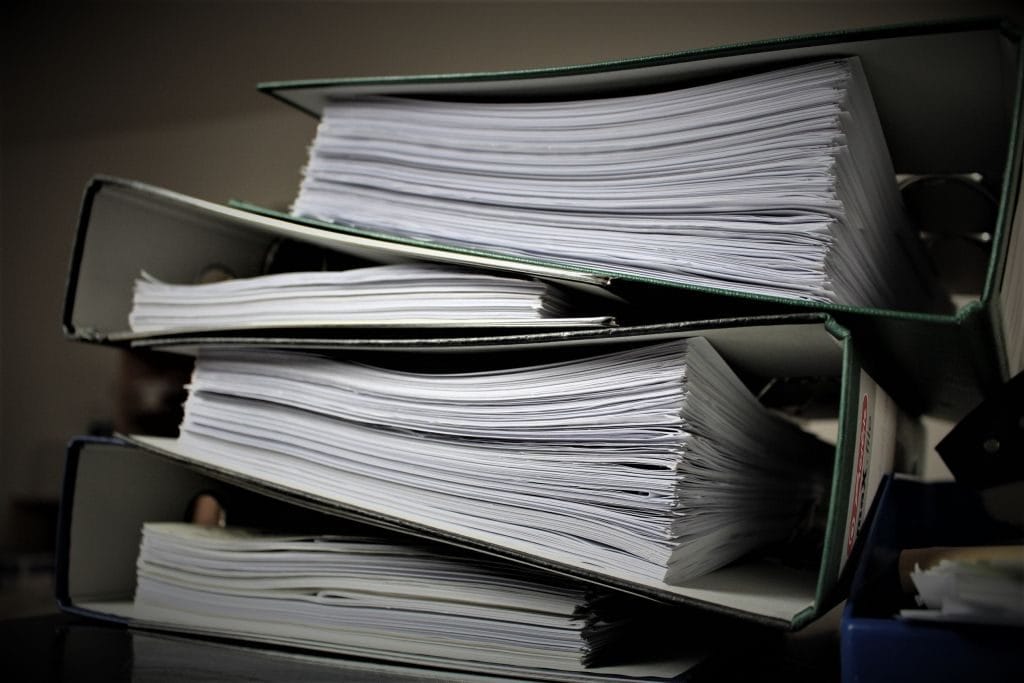 stack of binders filled with tax documents