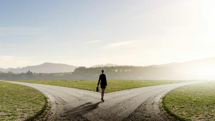 business woman making decision at a fork in the road